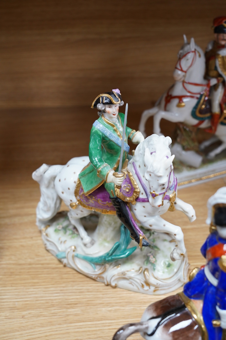 A group of eight Italian porcelain figures on horseback, tallest 30cm. Condition - fair